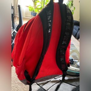 red and black bookbag from the brand PINK.